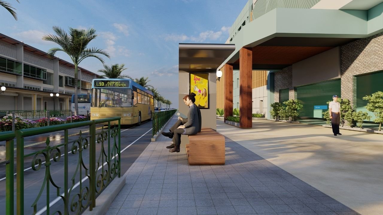 Living Node bench at a city bus stop with a passenger reading, a bus arriving and a wide solar canopy overhead